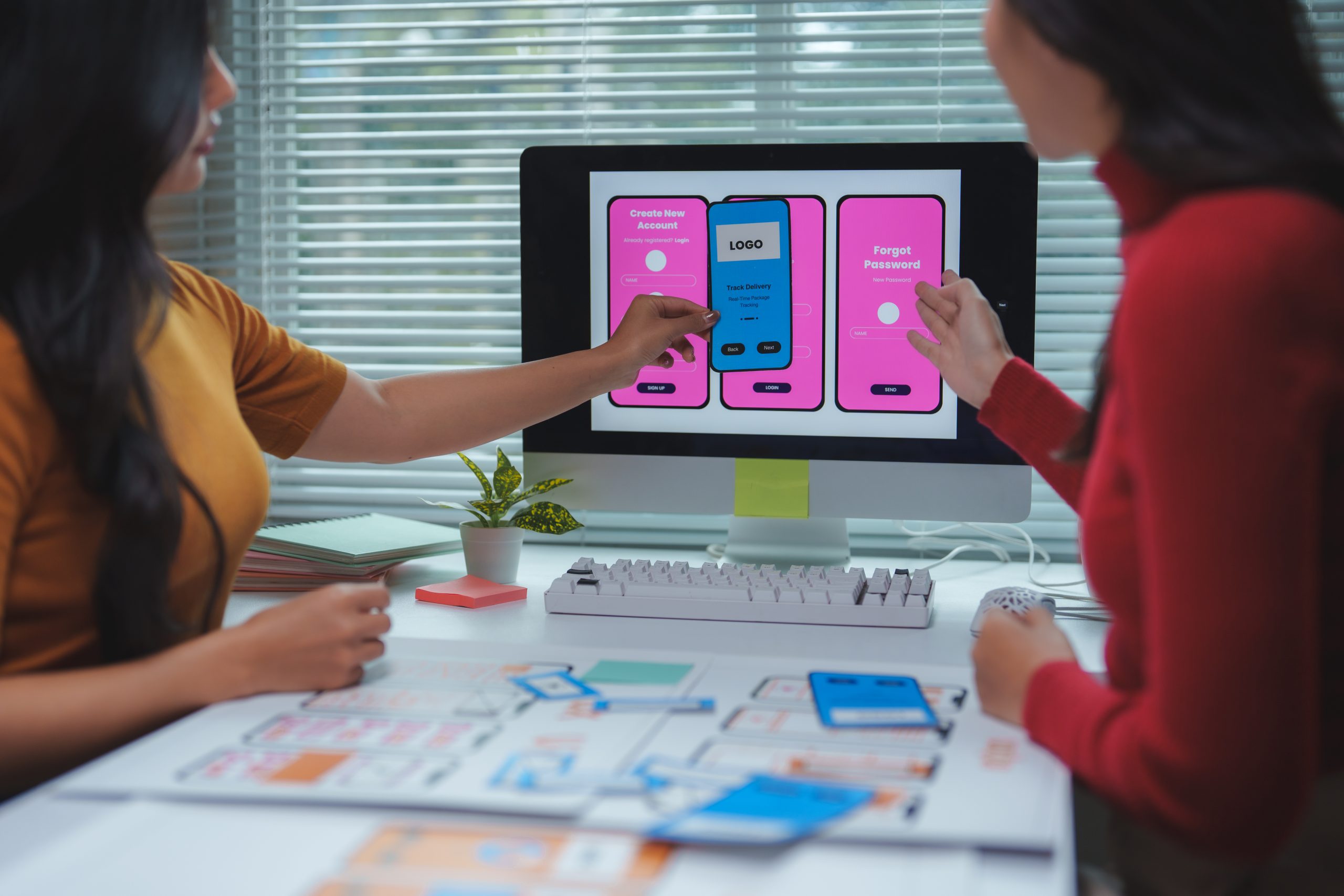Two female web designers working together on user interface and user experience of mobile application